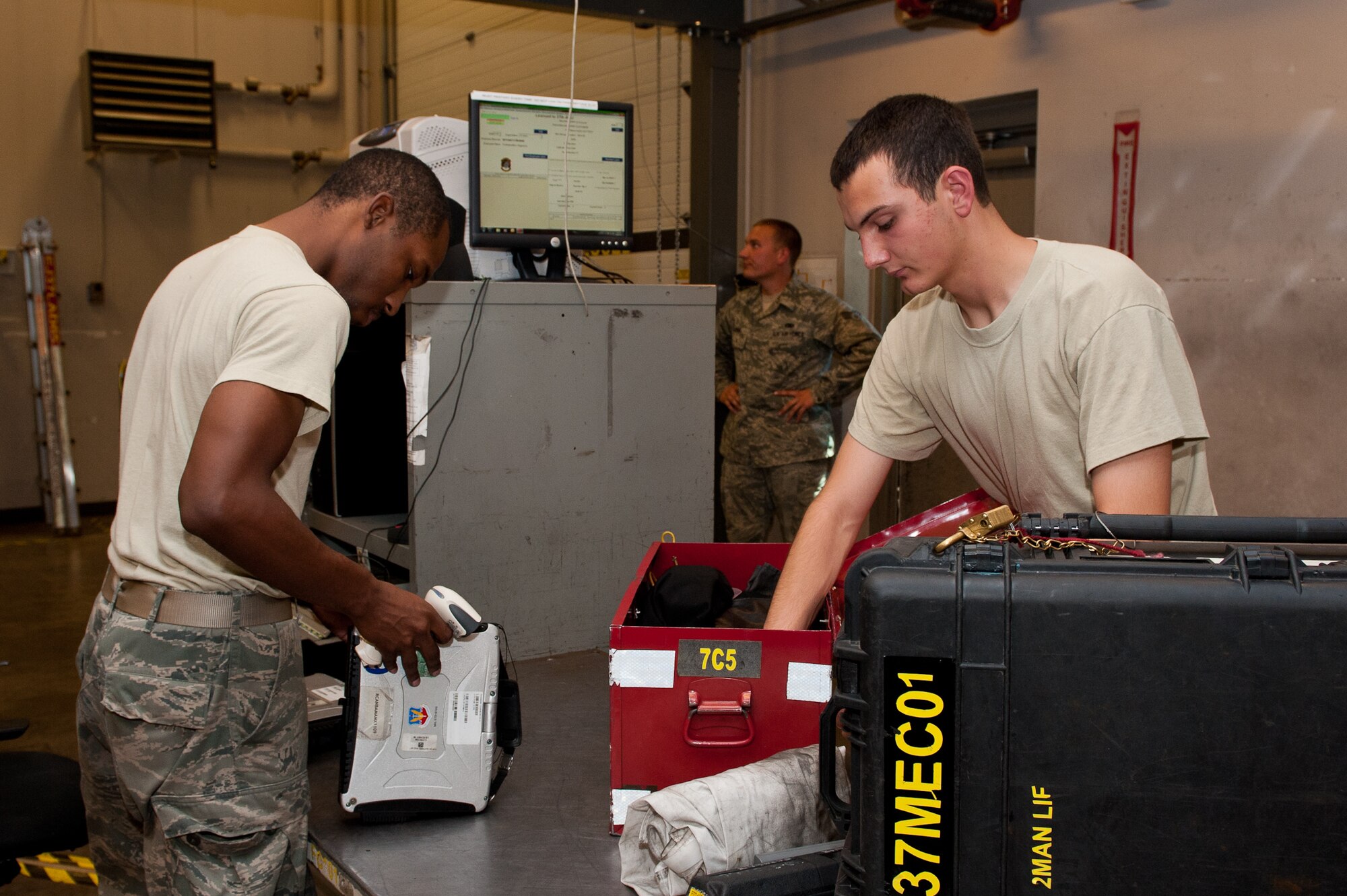 Airman 1st Class Deante Gibaldi, 28th Aircraft Maintenance Squadron crew chief, checks in equipment for Airman 1st Class Jonathan Balko, 28th AMXS electro-environmental systems apprentice, during a shift change in the maintenance support section on Ellsworth Air Force Base, S.D., June 26, 2012. The support section is responsible for issuing and receiving all equipment used for maintenance on Ellsworth’s B-1 fleet. (U.S. Air Force photo by Airman 1st Class Kate Thornton/Released)