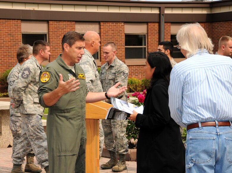148th Fighter Wing Commander Col. Frank Stokes speaks with Renee Passal during a press conference at the 148th Fighter Wing June 28, 2012.  Stokes spoke about the upcoming deployment to Kandahar Air Field, Afghanistan, where the 148th Fighter Wing is scheduled to put their new Block 50 F-16s to the test. (National Guard photo by Master Sgt. Ralph J. Kapustka.)