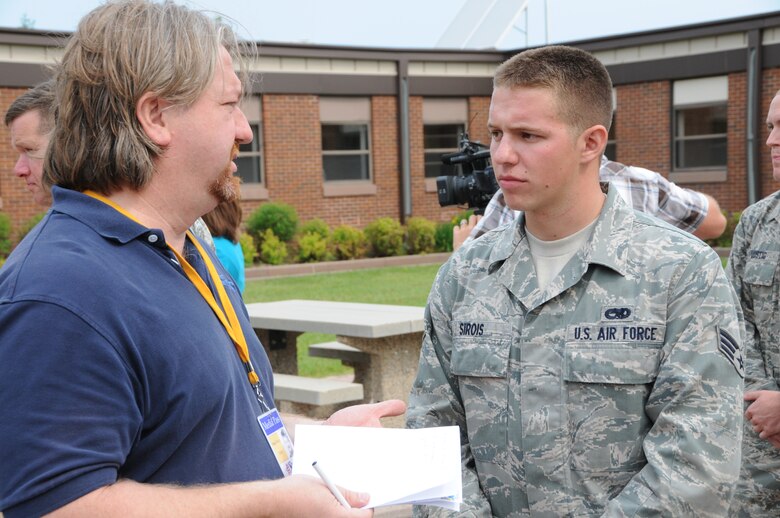 148th Fighter Wing member Senior Airman Michael Sirois speaks with Wade Petrich during a press conference at the 148th Fighter Wing June 28, 2012.  Sirois and his fellow Bulldogs are scheduled to deploy to Kandahar Air Field, Afghanistan for about two months in support of Operation Enduring Freedom. (National Guard photo by Master Sgt. Ralph J. Kapustka.)
