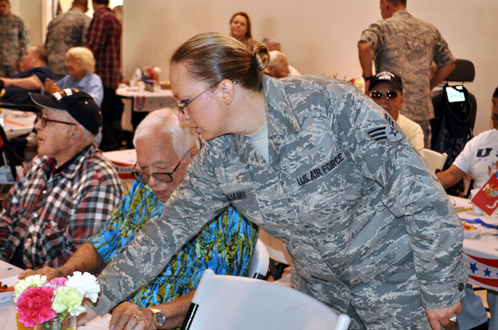 TRAVIS AIR FORCE BASE, Calif. --Senior Airman Valerie Williams, 349th Mission Support Squadron, serves mimosas and orange juice, during brunch with the veterans. U.S. Air Force photo / Senior Master Sgt. Ellen Hatfield) 