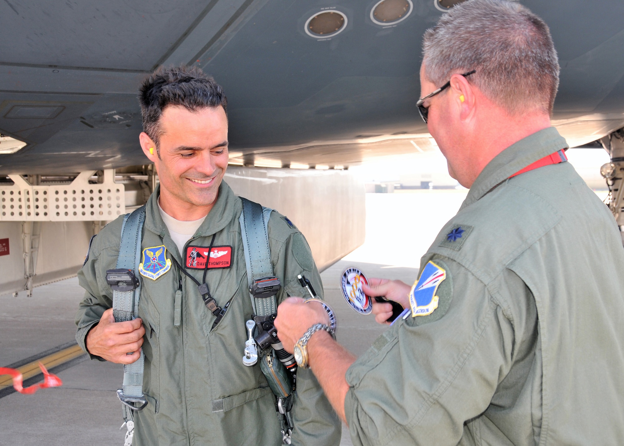 Lt. Col. Mike Pyburn, 131st Operations Group Commander, presents Lt. Col. Dave Thompson with his 1000 B-2 flying hour patch, June 27.  Only 31 pilots have ever reached 1000 B-2 hours, and just thirteen still actively fly the B-2 Stealth Bomber.  Seven of these elite pilots are 131st Bomb Wing Missouri Air National Guard members at Whiteman Air Force Base:  Lt. Col. Rhett Binger,  Lt. Col. Mike Pyburn, Lt. Col. Dave Thompson,  Maj. Jared Kennish, Maj. John Avery,  Maj. Geoffrey Billingsley, and Lt. Col. Mike Means, who has over 1500 B-2 flying hours.(National Guard Photo by Senior Master Sgt. Mary-Dale Amison.  RELEASED)