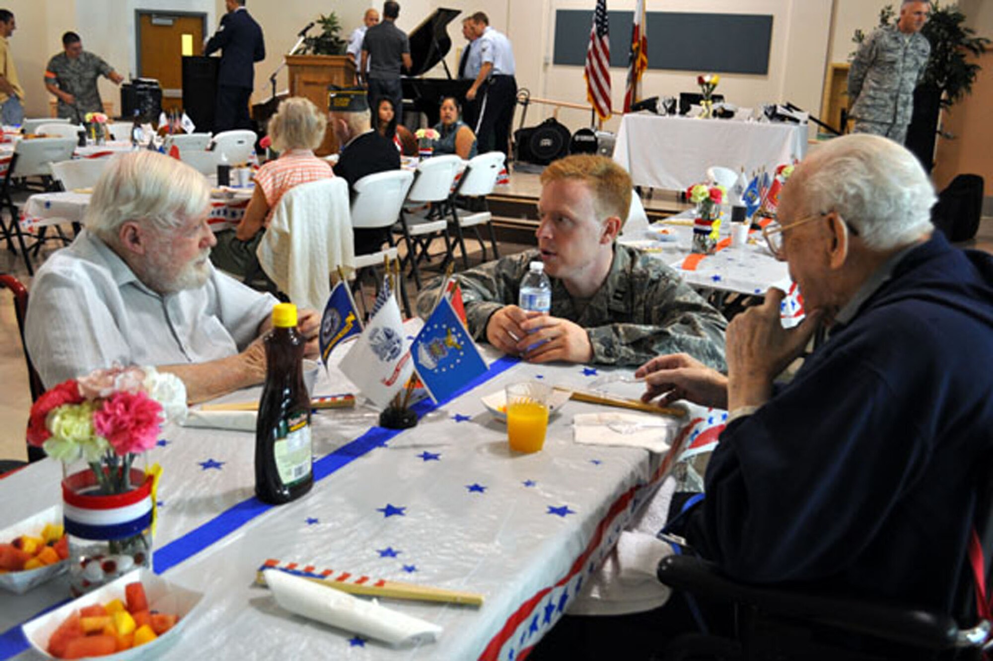 TRAVIS AIR FORCE BASE, Calif. -- Chaplain (Capt.) Matthew Ellis, 349th AMW, enjoys a chat with two residents of the California Veterans Home, Yountville, at Operation Gratitude 2012. (U.S. Air Force photo / Senior Master Sgt. Ellen Hatfield) 