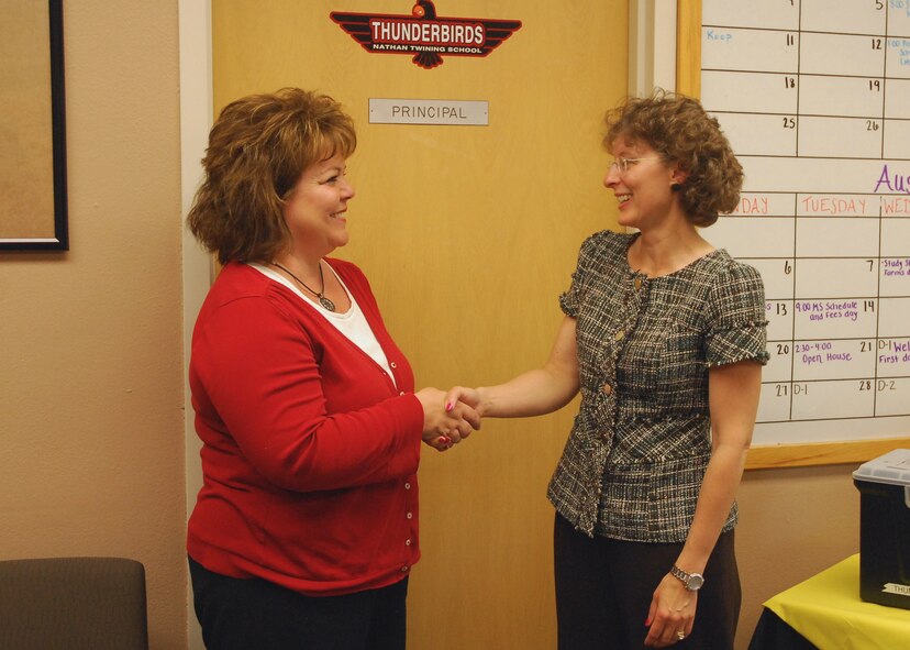 From right: Kelly Painter, school liaison officer, welcomes Dr. Mary Koopman, new Nathan F. Twining Elementary/Middle School principal June 22, 2012, on Grand Forks Air Force Base, N.D. Painter was named the latest Warrior of the Week for the 319th Air Base Wing. (U.S. Air Force photo/Brad Painter)