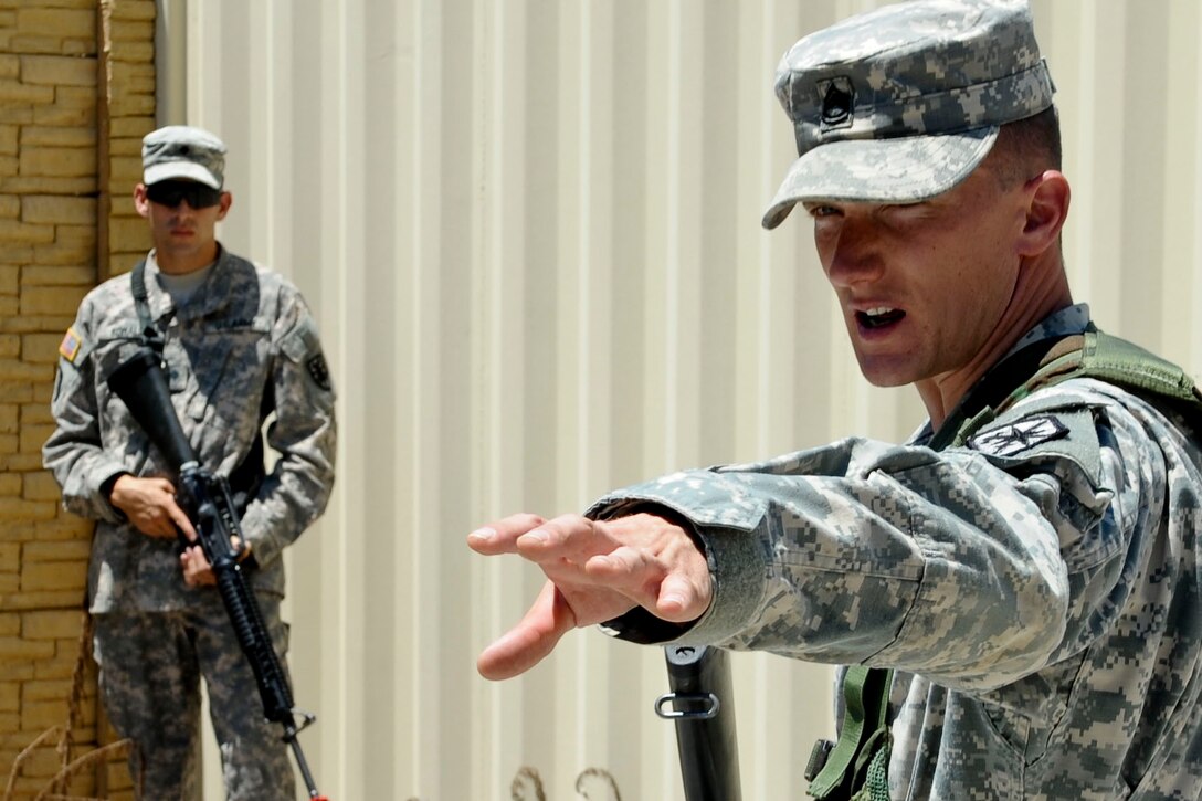 U.S. Army Sgt. 1st Class Adam McQuiston, Fort Leonard Wood, Mo., drill instructor,  explains the process of clearing a room to Soldiers as part of a graded station during the annual Drill Sergeant of the Year competition, hosted by Initial Military Training, U.S. Army Training and Doctrine Command, at Fort Eustis, Va. The yearly competition is designed by the previous year’s winner and is meant to challenge each drill sergeant both physically and mentally. (U.S. Air Force photo by Senior Airman Wesley Farnsworth/Released)