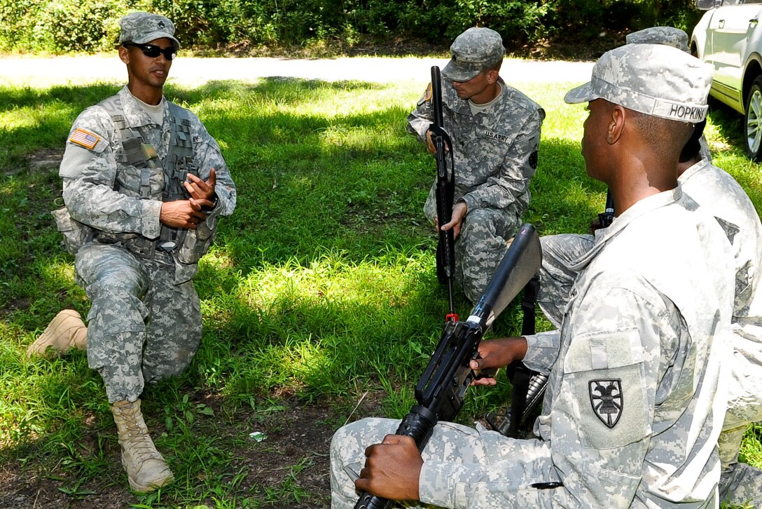 U.S. Army Staff Sgt. Denneit Disla, right, 98th Reserve Division drill sergeant, explains the process of  “breaking contact” to his squad, prior to completing the exercise, June 27, 2012, during the annual Drill Sergeant of the Year competition, hosted by Initial Military Training, U.S. Army Training and Doctrine Command, at Fort Eustis, Va. At this station Disla was required to explain, and then have his team properly execute the process. (U.S. Air Force photo by Senior Airman Wesley Farnsworth/Released)
