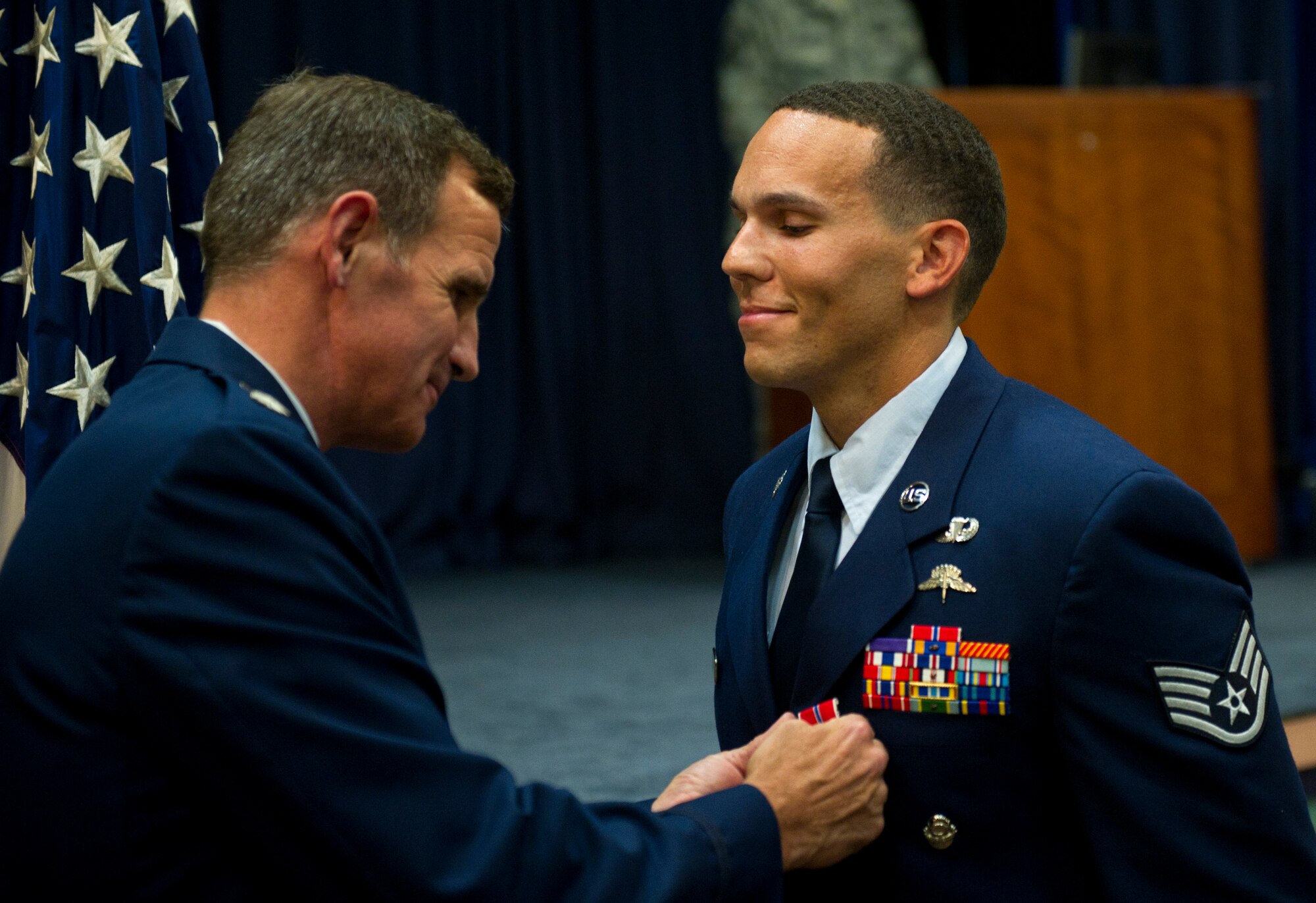 From right, U.S Air Force Staff Sgt. Johnnie Yellock Jr., a combat controller with the 23rd Special Tactics Squadron, stands at attention as Lt. Col. Chris Larkin, 23rd STS commander, presents him the Bronze Star Medal June 26, 2012 at Hurlburt Field, Fla. Yellock received the Bronze Star for his deployment to Afghanistan in 2011 -- a deployment in which he was significantly wounded by an Improvised Explosive Device. (U.S. Air Force photo by Staff Sgt. David Salanitri) 
