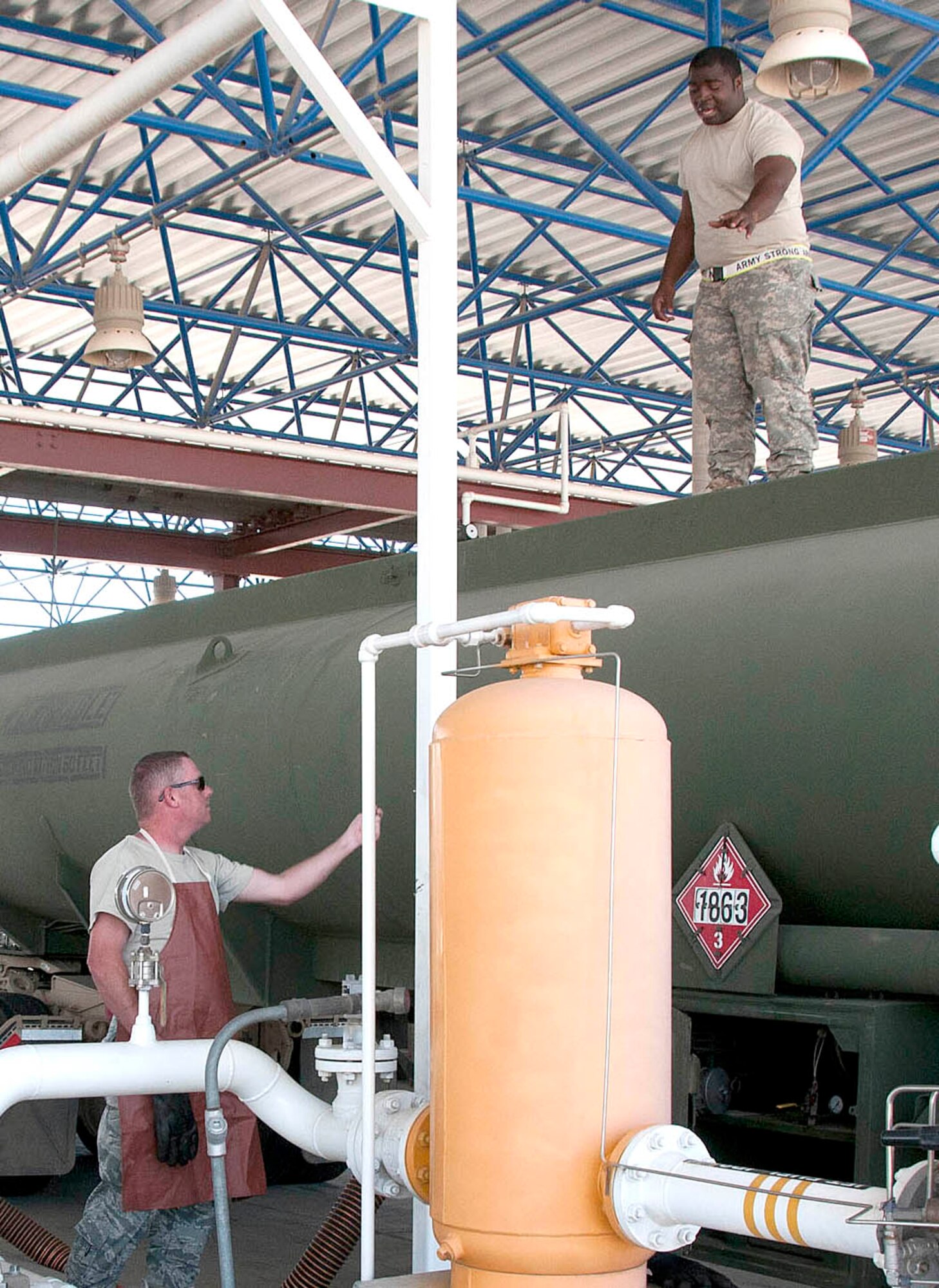 Army Reserve Pvt. Jamarcus McGee, top, checks a fuel tanker seal while Staff Sgt. Buzz Decker verifies seal numbers below before unloading fuel at the Arizona Air National Guard’s 162nd Fighter Wing at Tucson International Airport, June 21. Soldiers delivered JP8 to 73 F-16 Fighting Falcons here for two weeks as part of their annual Quartermaster Liquid Logistics Exercise. (U.S. Air Force photo/Master Sgt. Dave Neve)
