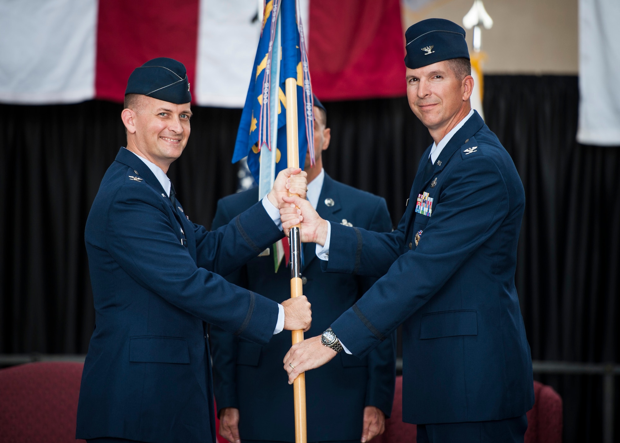 YOKOTA AIR BASE, Japan -- Col. Bill Knight, left, 374th Airlift Wing commander, and Col. Edward Brown, 374th Mission Support Group commander, hold the 374 MSG guidon during the 374th MSG change of command ceremony at Yokota Air Base, Japan, on June 27, 2012. The guidon is a tradition dating back to Roman times, where military units would carry a banner with their emblem into battle. The passing of the guidon to the new commander signifies the start of that responsibility. (U.S. Air Force photo by Tech. Sgt. Samuel Morse)