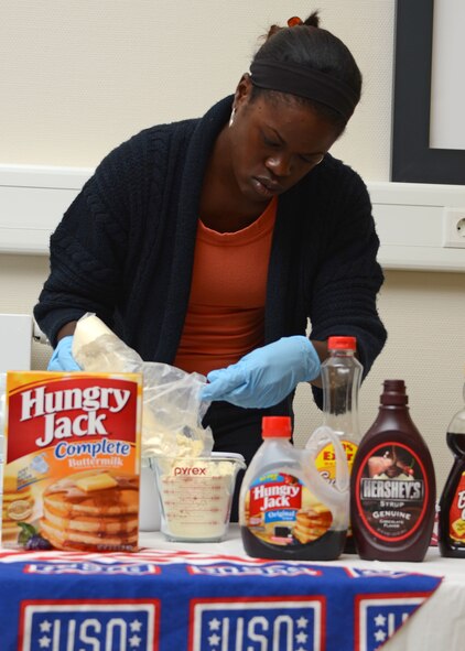 U.S. Air Force Staff Sgt. Dorrin Finley, 175th Force Support Squadron, Maryland Air National Guard, makes pancakes for wounded military members at the Contingency Aeromedical Staging Facility, Ramstein Air Base, Germany, June 22, 2012.  Finley volunteered with the USO on her day off during annual training in Germany. (National Guard photo by U.S. Air Force Staff Sgt. Benjamin Hughes)