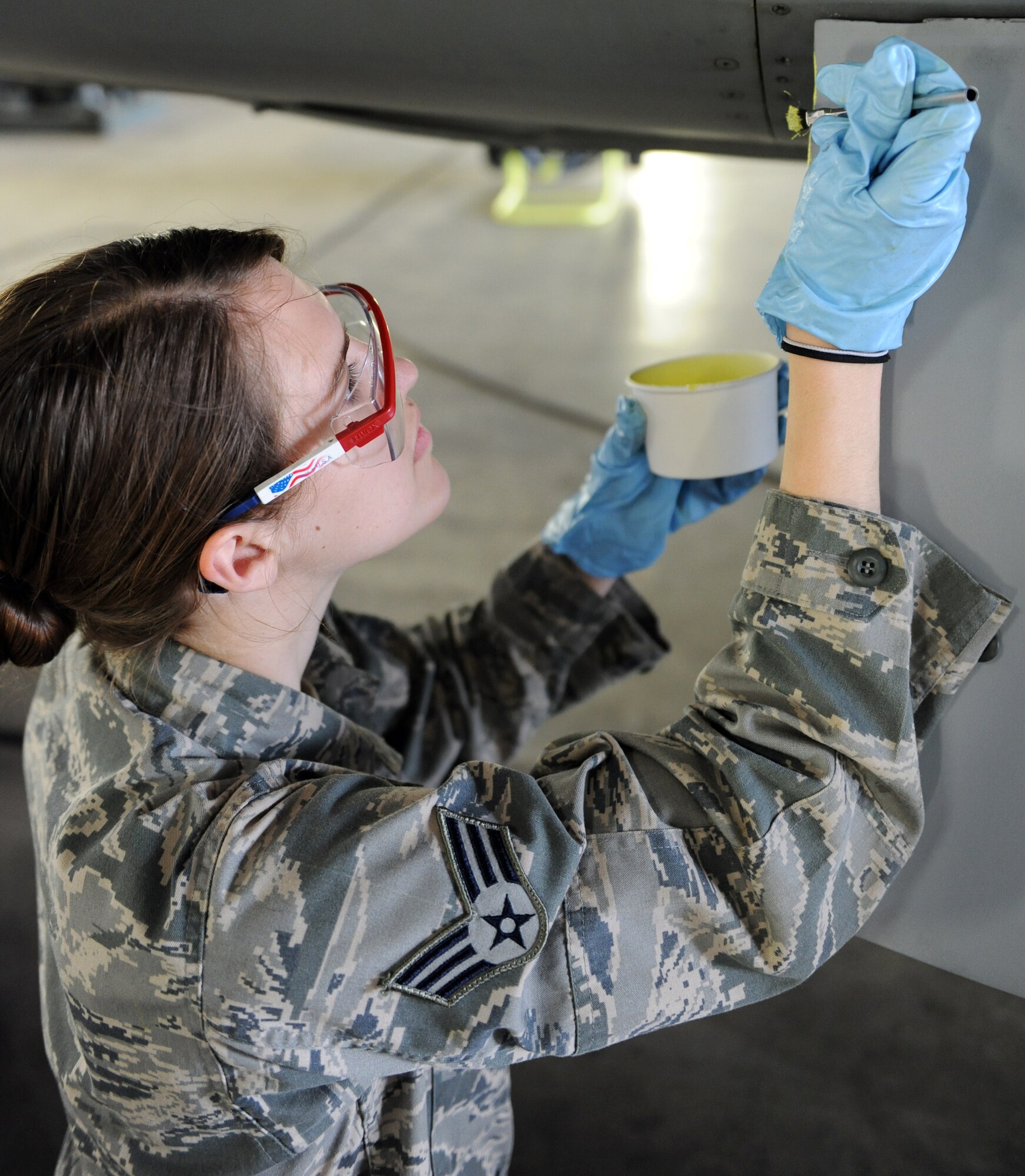 U.S. Air Force Senior Airman Brooke Williams, 35th Maintenance Squadron aircraft structural maintenance journeyman, puts primer on the horizontal step of an F-16 Fighting Falcon aircraft at Misawa Air Base, June 28, 2012. The primer protects the metal on the aircraft from corrosion. (U.S. Air Force photo by Airman 1st Class Kia Atkins/Released)