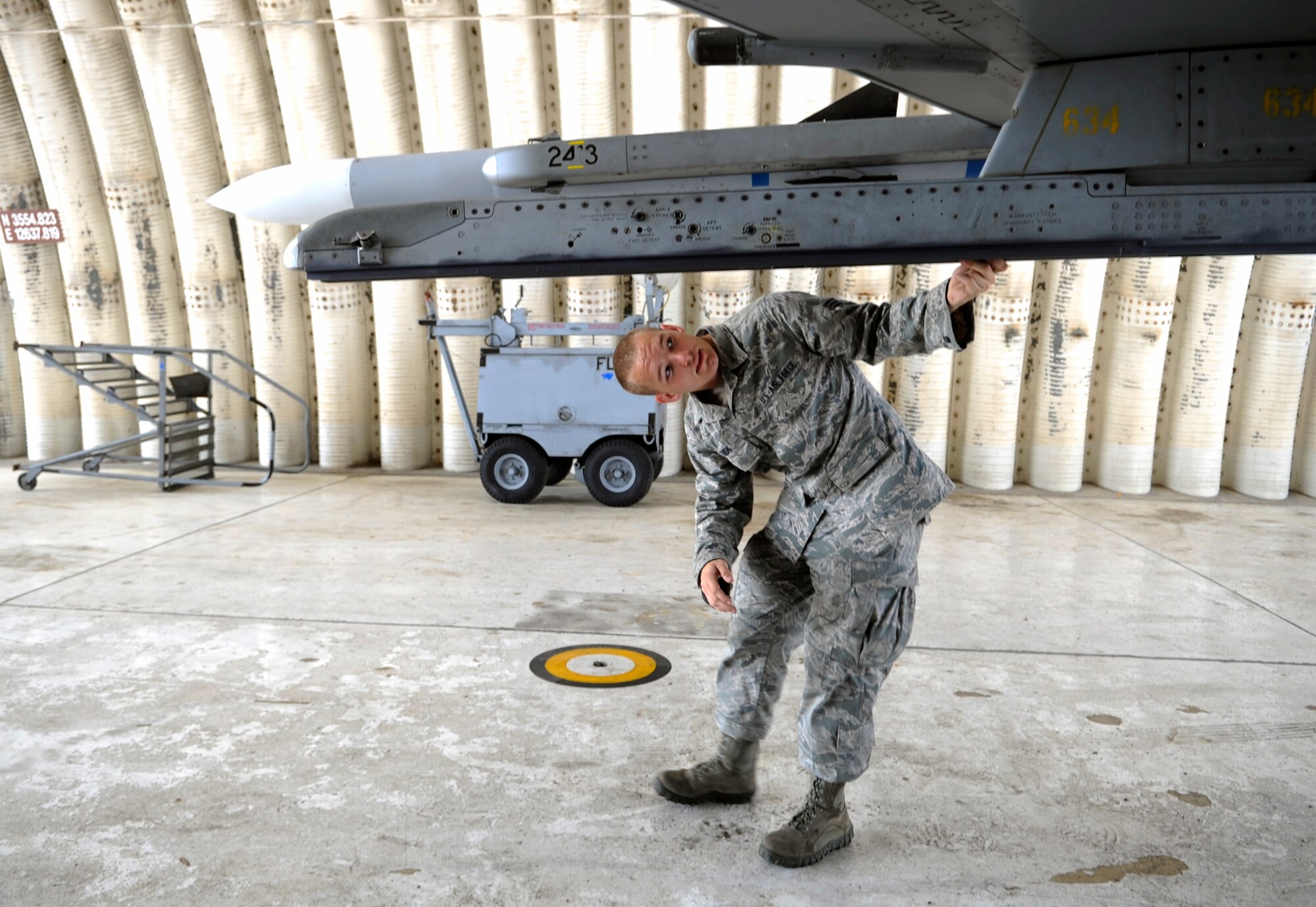 Senior Airman Ryan Rush, 80th Aircraft Maintenance Unit weapons load team member, makes sure an F-16 Fighting Falcon is flight-ready June 23, 2012, at Kunsan Air Base, Republic of Korea. The 8th Aircraft Maintenance Squadron prepared 16 aircraft to participate in joint naval operations with the U.S. and Republic of Korea navies. (U.S. Air Force photo/Senior Airman Brigitte N. Brantley)