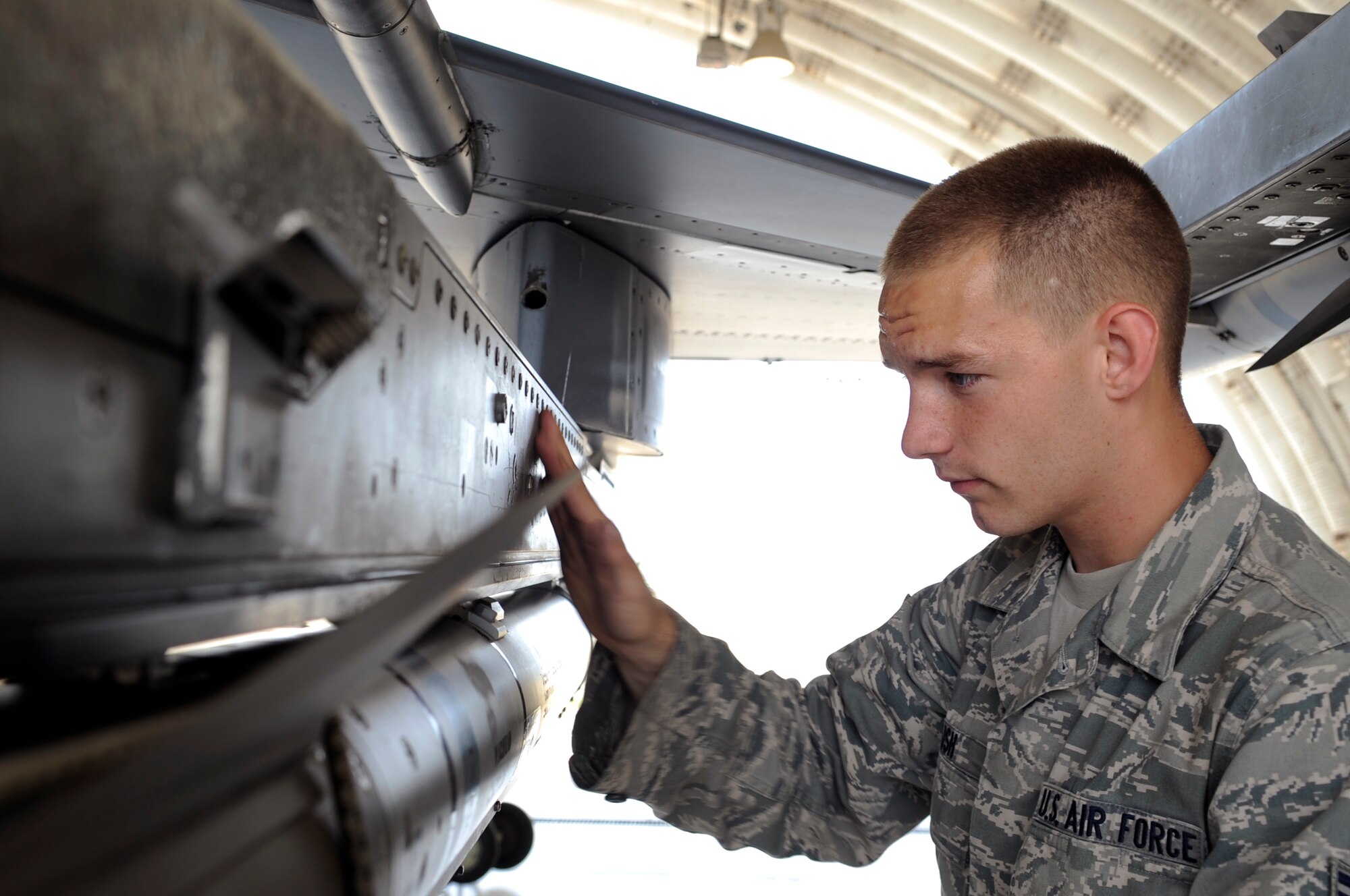 Senior Airman Ryan Rush, 80th Aircraft Maintenance Unit weapons load team member, checks the skin of an F-16 Fighting Falcon June 23, 2012, at Kunsan Air Base, Republic of Korea, before it takes off for joint naval operations in the Yellow Sea. The operations were held to reinforce regional security and stability. (U.S. Air Force photo/Senior Airman Brigitte N. Brantley)