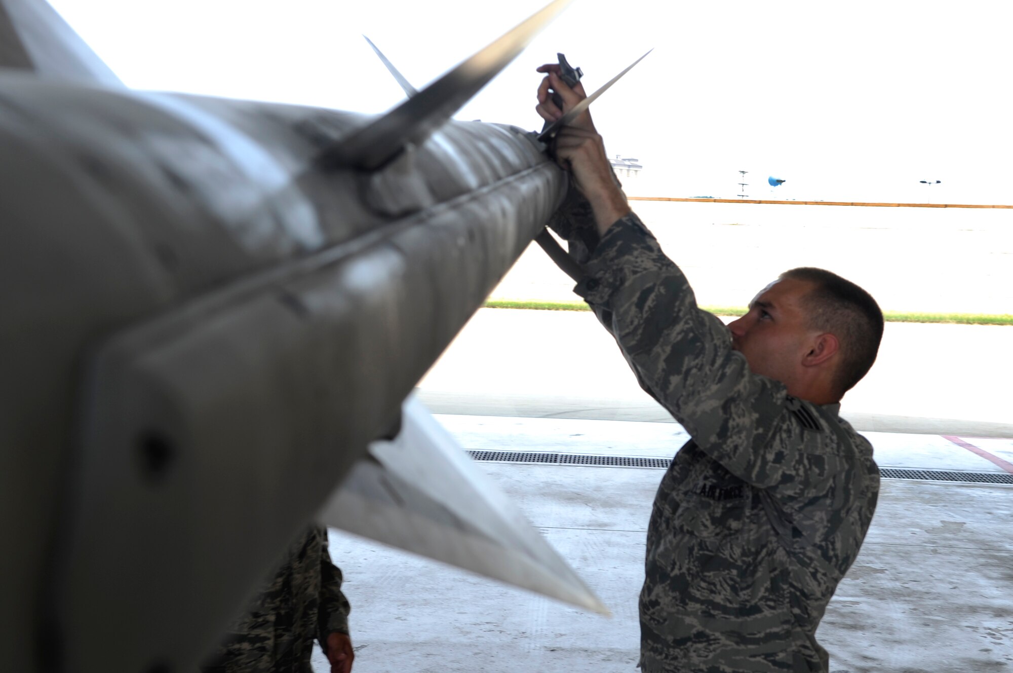 Senior Airman Ryan Rush, 80th Aircraft Maintenance Unit weapons load team member, prepares an F-16 Fighting Falcon for flight June 23, 2012, at Kunsan Air Base, Republic of Korea, as it heads to the Yellow Sea for joint naval operations. The operations covered integrated flight operations, surface and anti-submarine warfare training, air defense, replenishment at sea, dynamic ship maneuvers and liaison officer exchanges. (U.S. Air Force photo/Senior Airman Brigitte N. Brantley)