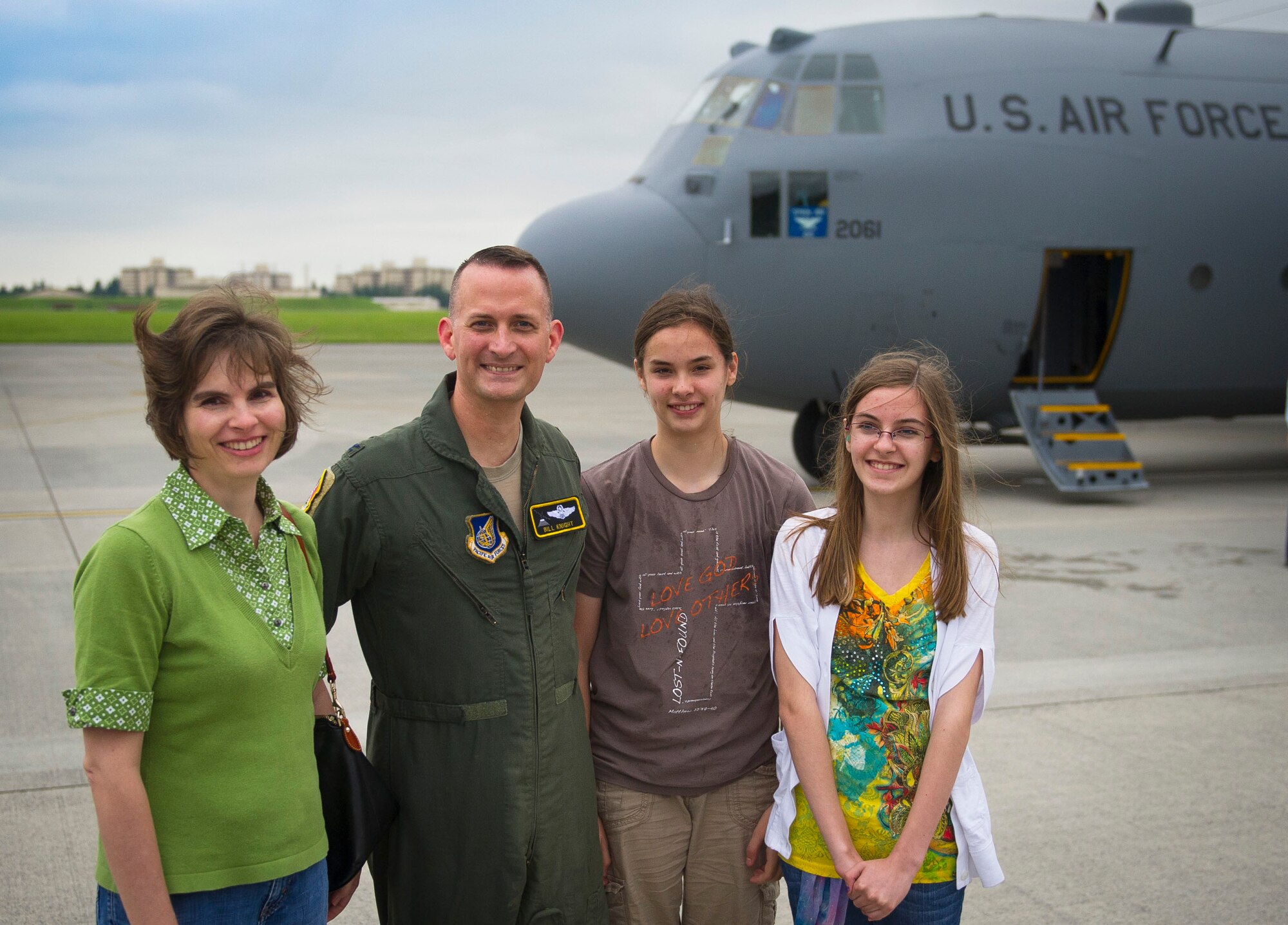 YOKOTA AIR BASE, Japan -- Left to right, Col. Bill Knight, 374th Airlift Wing commander, his wife, Susan, and daughters, Melissa and Emily, stand before a C-130 Hercules after Knight completed his "fini-flight" at Yokota Air Base, Japan, June 25, 2012. (U.S. Air Force photo by Staff Sgt. Chad C. Strohmeyer)