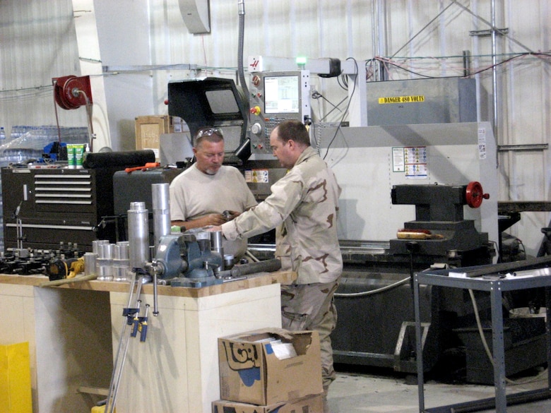 BAGRAM AIRFIELD, Afghanistan — U.S. Army Research, Development and Engineering Command Field Assistance in Science and Technology-Center, or RFAST-C, technician Glenn Wetherell, (left), and engineer Matthew Collins discuss modifications to a project component.