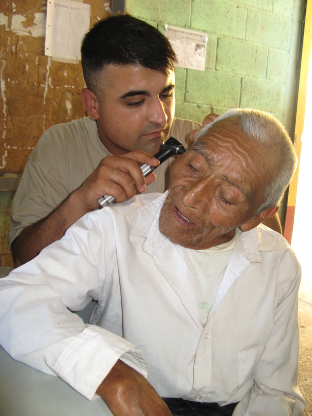 Army Spc. Tony Montano from the 352nd Combat Support Hospital checks the ears of an 80-year-old Guatemalan man during a five-day medical readiness training exercise in Pocola, Guatemala, June 27, 2010. DOD photo by Donna Miles 
