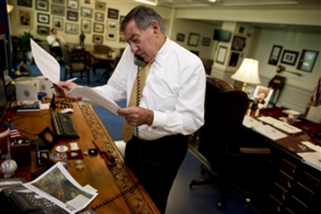 Secretary of Defense Leon E. Panetta works in his office he receives an update from Army Gen. Charles H. Jacoby, Jr., commander, Northern Command, about the Colorado wildfires threatening Colorado Springs and the United States Air Force Academy, on June 28, 2012.   