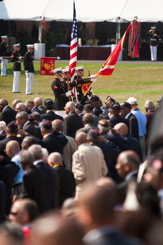 The Marine Corps Color Guard presents the official Battle Color during a Congressional Gold Medal presentation ceremony at the historic parade grounds of Marine Barracks Washington June 28. In 1942, President Roosevelt established a presidential directive giving African Americans an opportunity to be recruited into the Marine Corps. Between 1942 and 1949 approximately 20,000 Af...rican American Marines received basic training at the segregated Montford Point instead of the traditional boot camps of Parris Island, S.C. and San Diego, Calif. These men fought for their country with honor and valor that are hallmarks of the Corps, but they were not treated as equals to their white counterparts at the time. Gen. James F. Amos, commandant of the Marine Corps, set out to begin to right this wrong when he invited the Montford Point Marines to the Barracks Aug. 26, 2011 to be the guests of honor at a Friday Evening Parade, bringing their story to the national forefront and starting a chain of events that lead to this historic day.