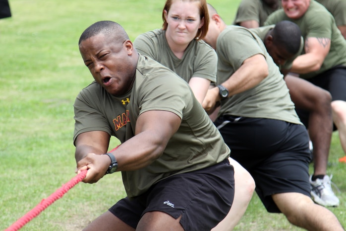 Marines with Marine Wing Support Squadron 171 headquarters company, compete in the tug-of-war event during the MWSS-171 field meet held at the IronWroks Gym here June 29, 2012. The tug-of-war event required the participants to lay down with their feet across the rope and upon receiving the signal, scramble to their feet and begin to pull the rope.