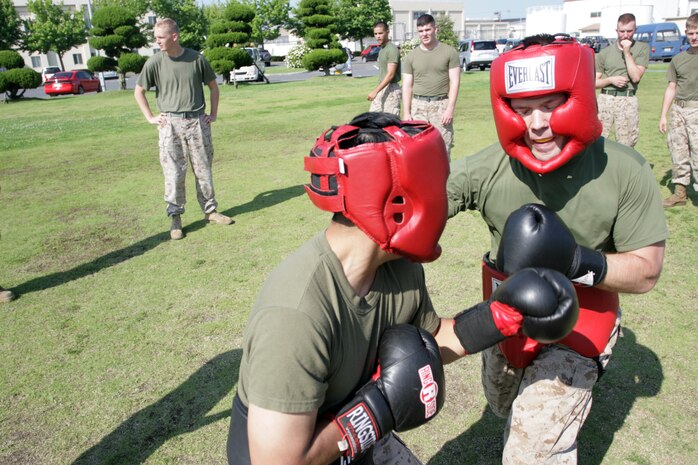 Pfc. Joshua A. Daehnke (right) and Lance Cpl. Alfredo Robles Jr., Marine Aircraft Group 12 supply administration and operations specialists, duke it out during the MAG-12 fight night here June 29, 2012. Fight night built camaraderie while giving the Marines an opportunity to train and maintain their combat mind-set. Marines were able to choose their opponents, whether to settle a squall or just to battle in a safe, friendly, competitive environment.
