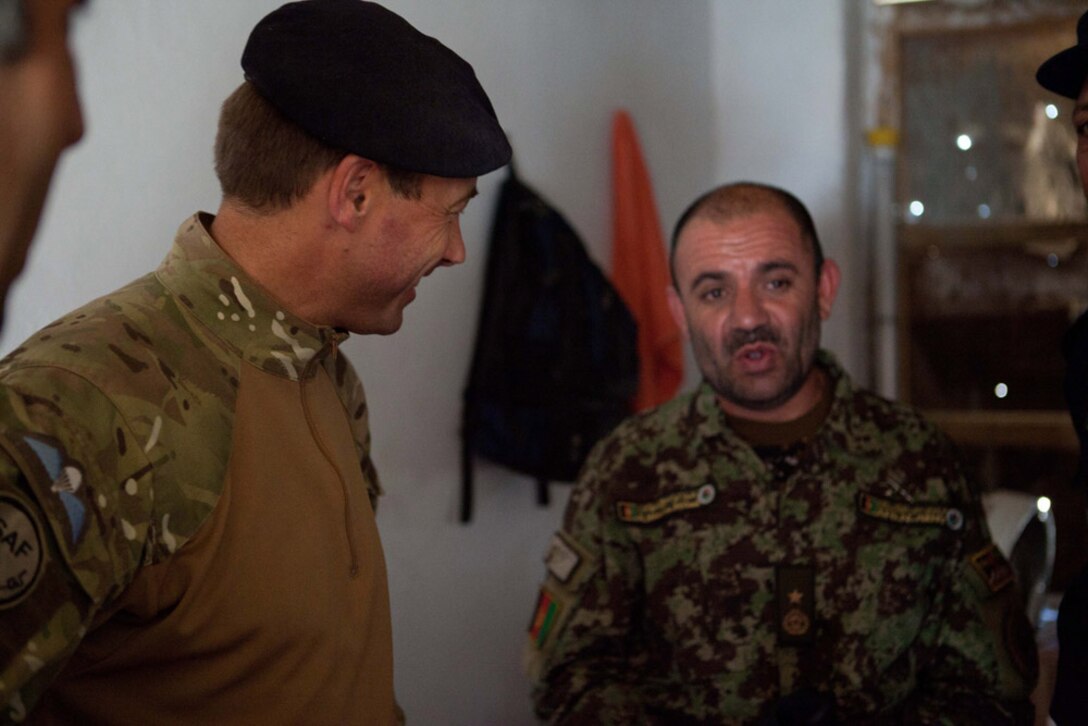 British Army Brigadier Stuart Skeates, deputy commander of Regional Command (Southwest), listens to Afghan National Army Brig. Gen. Abdul Wasea talk inside Delaramâ€™s operations coordination center, June 27, 2012. Wasea, commanding general, 2nd Brigade, 215th Corps, and other Afghan regional leaders met with Brig. Skeates and Marines from Regimental Combat Team 6 to discuss the transition of security responsibilities in Delaram to Afghan National Security Forces. One improvement Brig. Skeates recommended was an enhanced capability at the districtâ€™s OCC. The OCC is important for sharing information among the components of ANSF and with provincial leaders.
