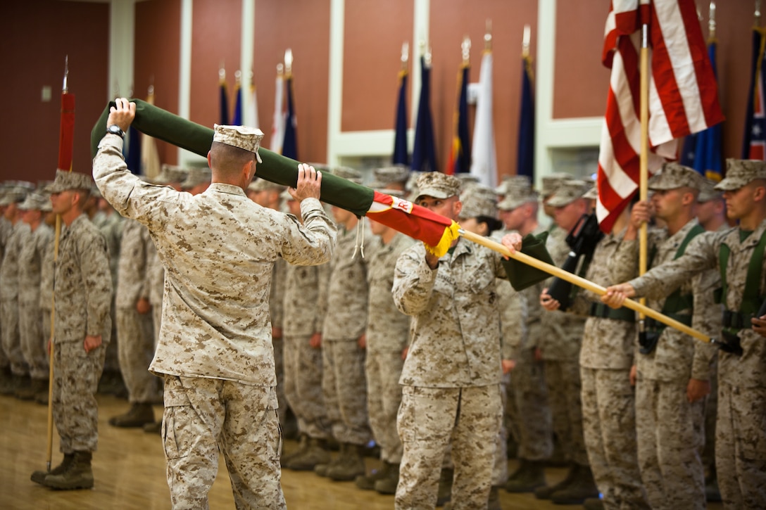 Col. Michael M. Sweeney, commanding officer of II Marine Expeditionary Force Headquarters Group, and Sgt. Maj. Craig D. Cressman, sergeant major of II MHG, uncase the battle colors of 2nd Law Enforcement Battalion during the battalion's activation ceremony at Marine Corps Base Camp Lejeune, N.C., June 26. The battalion will be a force multiplier to the operating forces by assisting in a variety of missions that include law enforcement, route regulation, humanitarian assistance, nonlethal weapons training and military working dog employment.