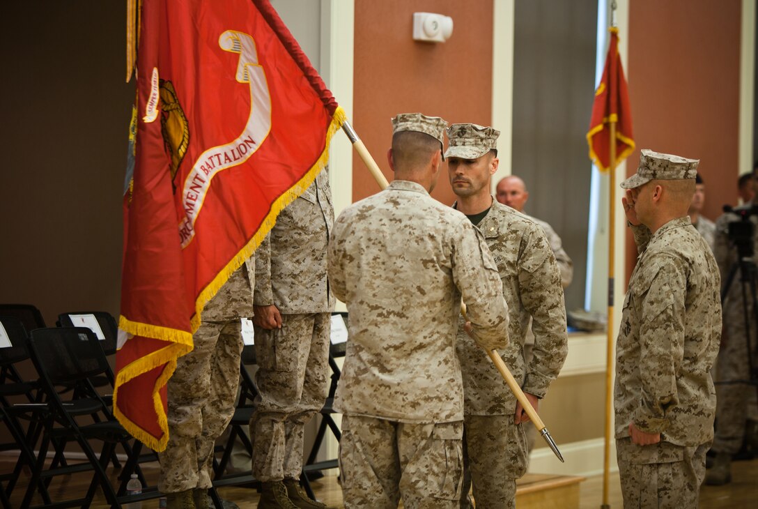 Major Eric Young, commanding officer of 2nd Law Enforcement Battalion, is presented with the battalion's battle colors by Col. Michael M. Sweeney, commanding officer of II Marine Expeditionary Force Headquarters Group, during 2nd LEB's activation ceremony at Marine Corps Base Camp Lejeune, N.C., June 26. The battalion will be a force multiplier to the operating forces by assisting in a variety of missions that include law enforcement, route regulation, humanitarian assistance, nonlethal weapons training and military working dog employment.