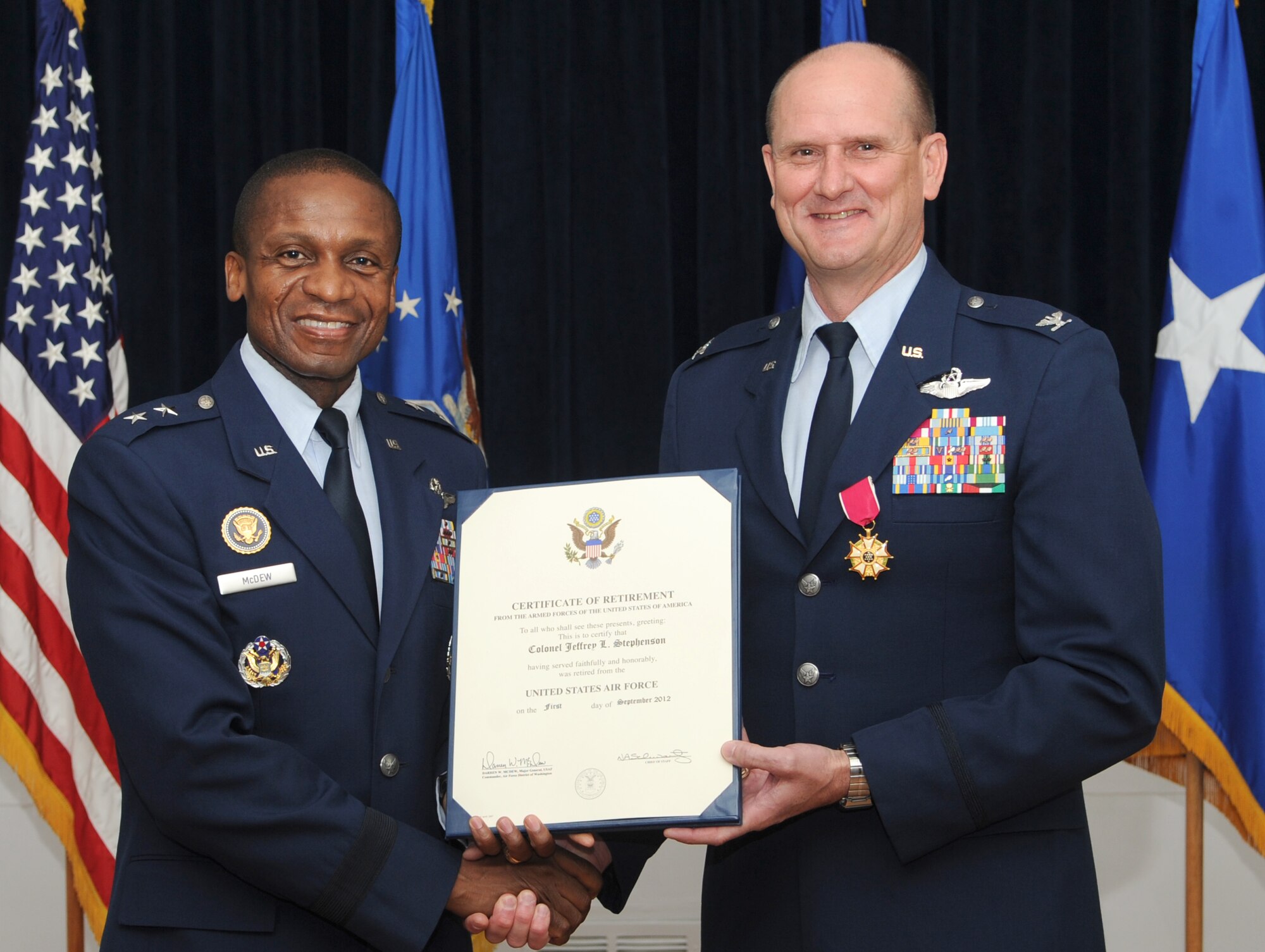 Air Force District of Washington Commander Maj. Gen. Darren W. McDew presents AFDW Vice Commander Col. Jeffrey L. Stephenson his certificate of retirement June 28, 2012 on Joint Base Andrews, Md. Stephenson spent his final year in uniform leading the Airmen of AFDW.