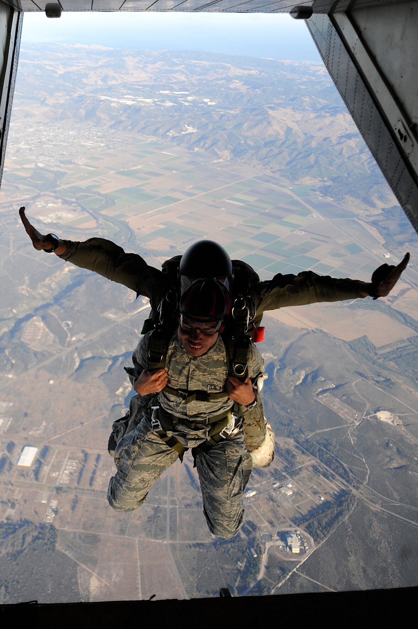 VANDENBERG AIR FORCE BASE, Calif. -- Airman 1st Class Joshua Brown, 30th Medical Operations Squadron medical technician, jumps tandem with an Air Force pararescueman during a tandem jump training exercise at the flightline here Wednesday, June 27, 2012. The training held certifies the pararescuemen to maintain their jump qualifications. (U.S. Air Force photo/Staff Sgt. Andrew Satran) 

 