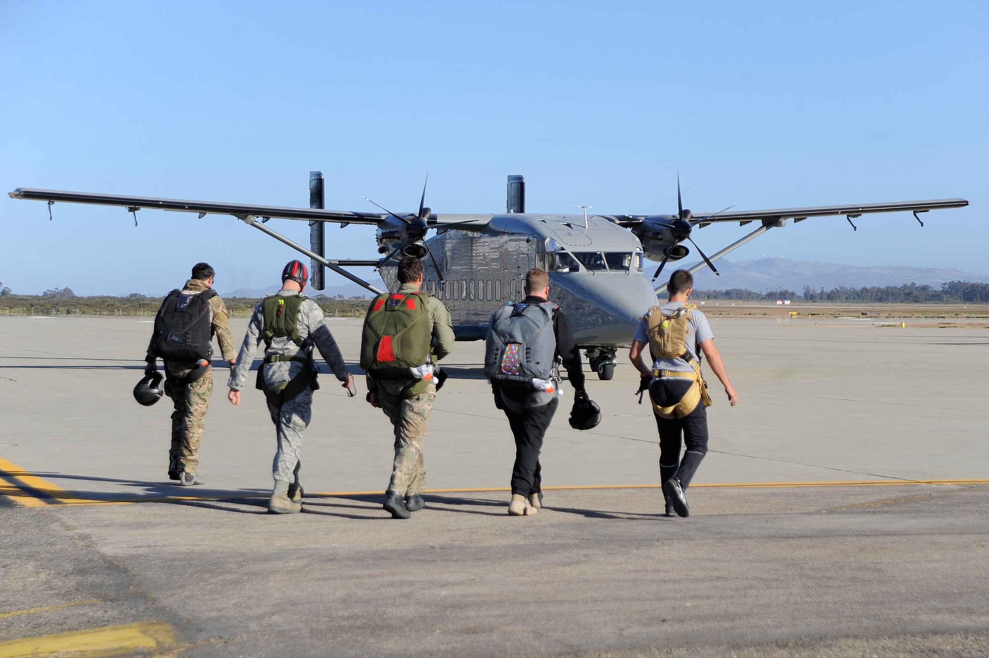 VANDENBERG AIR FORCE BASE, Calif. -- Members from Team V, the Army and Air Force Pararescue, walk to an Army C-23 Sherpa during a tandem jump training exercise at the flightline here Wednesday, June 27, 2012. The training held certifies the pararescuemen to maintain their jump qualifications. (U.S. Air Force photo/Staff Sgt. Andrew Satran) 

 