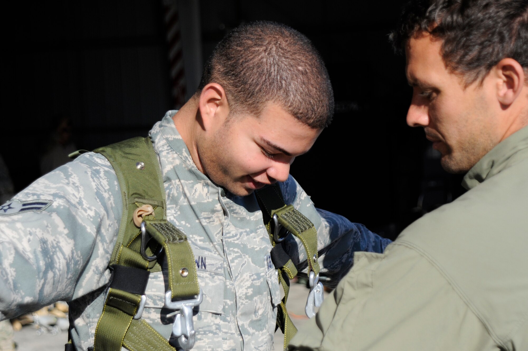 VANDENBERG AIR FORCE BASE, Calif. -- Airman 1st Class Joshua Brown, 30th Medical Operations Squadron medical technician, gets a final check from an Air Force pararescueman during a tandem jump training exercise at the flightline here Wednesday, June 27, 2012. The training held certifies the pararescuemen to maintain their jump qualifications. (U.S. Air Force photo/Staff Sgt. Andrew Satran) 

 