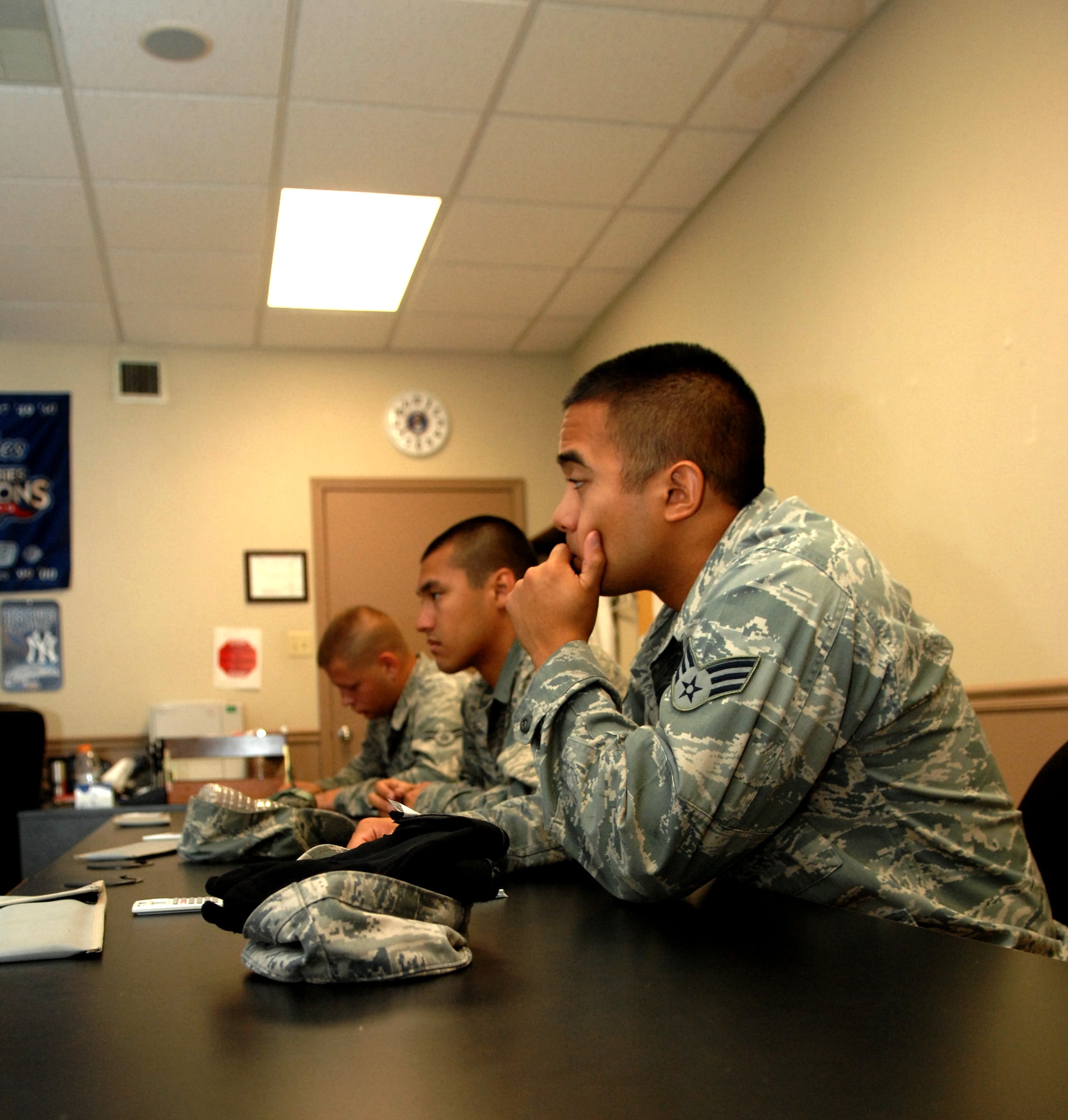 Senior Airman Eric Abes-Guzman, 2nd Aircraft Maintenance Squadron airframe power plant general Field Training Detachment 5 student, sits with two of his classmates during a lecture about the technical orders they will use to help maintain the B-52H Stratofortress. The FTD teaches the class about the aircraft specific items from nose to tail and everything in between with a hands-on approach to learning. (U.S. Air Force photo/Staff Sgt. Jason McCasland)(RELEASED)