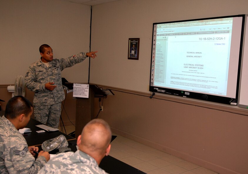 Tech. Sgt. Raul Guzman, 372nd Training Squadron Field Training Detachment 5 airframe power plant general instructor, shows students how to use and understand the  technical orders used on the B-52H Stratofortress at Barksdale Air Force Base, La., June 27. The two to six week FTD course teaches maintenance personnel a combination of basic theory, hands-on wrench turning and troubleshooting. (U.S. Air Force photo/Staff Sgt. Jason McCasland)(RELEASED)