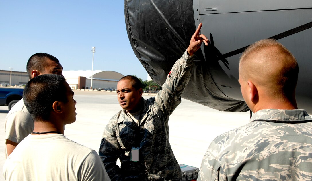 Tech. Sgt. Raul Guzman, 372nd Training Squadron Field Training Detachment 5 airframe power plant general instructor, points out to three students different parts of an engine cowling at Barksdale Air Force Base, La., June 27. The FTD teaches the class about aircraft specific items from nose to tail and everything in between. (U.S. Air Force photo/Staff Sgt. Jason McCasland)(RELEASED)