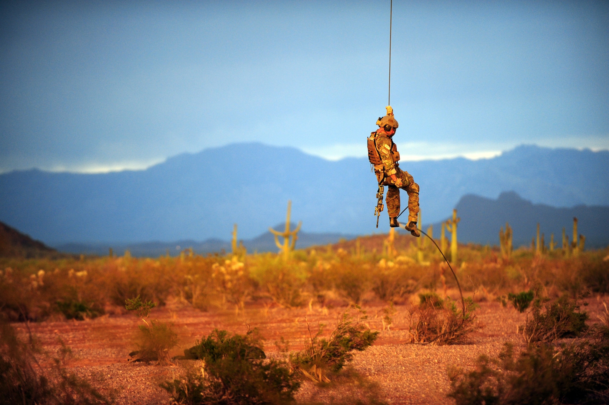 A U.S. Air Force pararescueman from the 48th Rescue Squadron repels from a HH-60 Pave Hawk during a day tactical training mission in Tucson, Ariz., June 27, 2012. Part of the training was to descend from the Pave Hawk by using both a repel system and rope. (U.S. Air Force photo by Airman 1st Class Camilla A Griffin/Released)