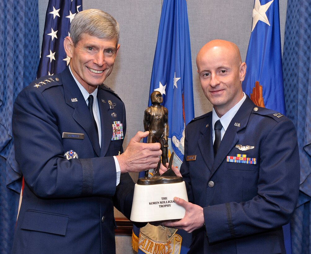 Air Force Chief of Staff Gen. Norton Schwartz presents the Koren Kolligian Jr. Trophy to 2011 recipient Capt. Frank Baumann during a Pentagon ceremony June 27, 2012. Baumann is an instructor pilot stationed at Sheppard Air Force Base, Texas. The trophy, established in 1958, is the only Air Force individual safety award personally presented by the Air Force Chief of Staff. (U.S. Air Force photo/Michael J. Pausic)
