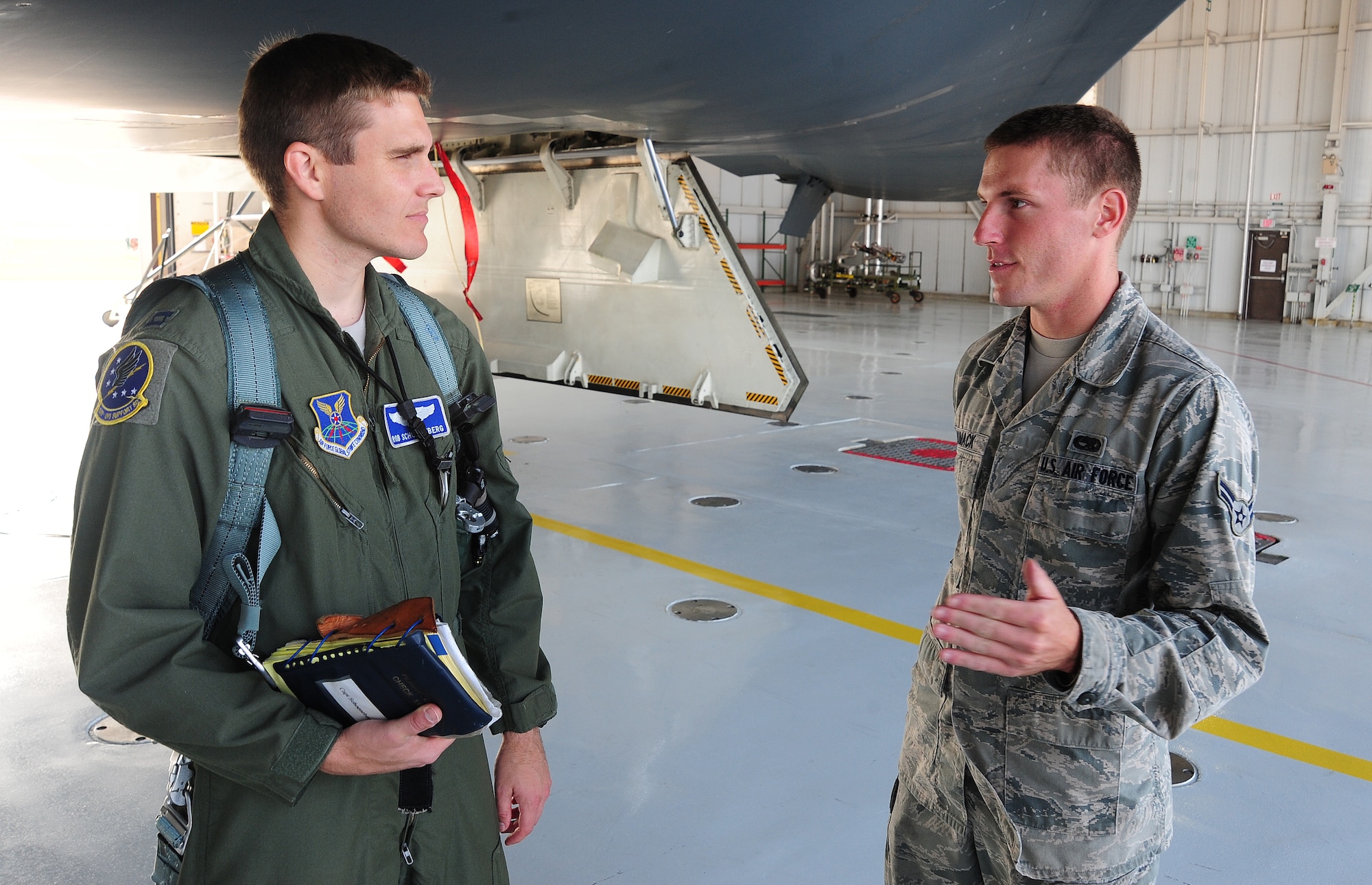 WHITEMAN AIR FORCE BASE, Mo. -- Capt. Robert Schoeneberg, 509th Operations Support Squadron B-2 Spirit pilot, speaks to Airman 1st Class Jimmy Womack, 13th Aircraft Maintenance Unit B-2 Spirit crew chief, as part of a preflight inspection before participating in the bomber operations portion of Global Strike Challenge 2012 June 26. The competition began June 25 and continues through November. (U.S. Air Force photo/Senior Airman Nick Wilson) (Released)