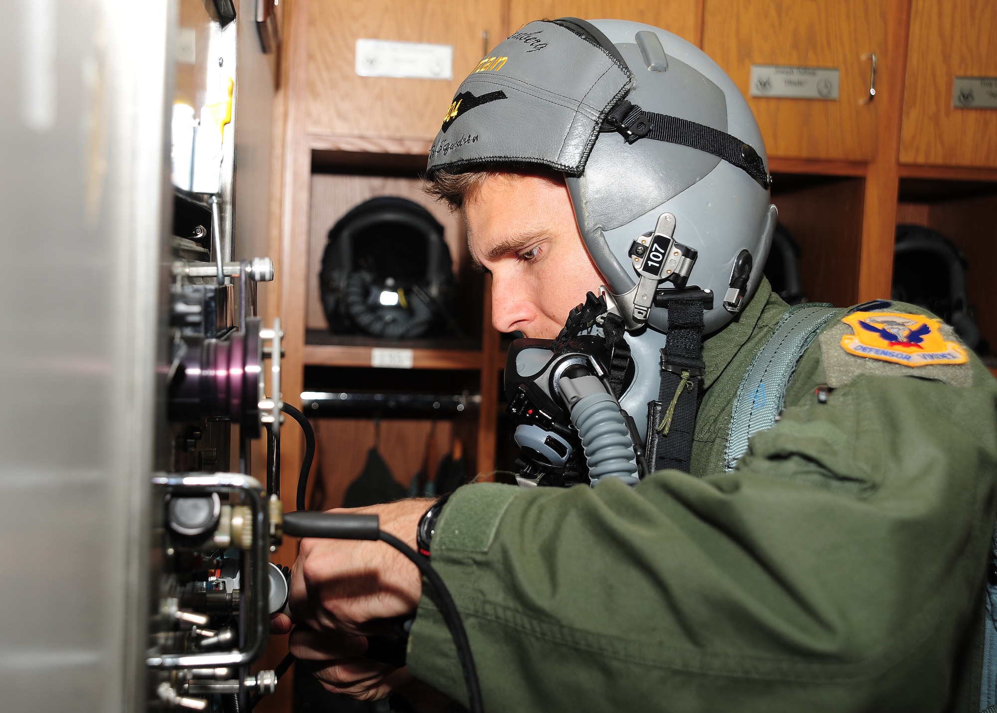 WHITEMAN AIR FORCE BASE, Mo. -- Capt. Robert Schoeneberg, 509th Operations Support Squadron B-2 Spirit pilot, tests his flight equipment before stepping to the flightline to participate in the bomber operations portion of Global Strike Challenge 2012 June 26. Pilots are judged on high altitude bombing, special instructions completion and electronic countermeasures. (U.S. Air Force photo/Senior Airman Nick Wilson) (Released)
