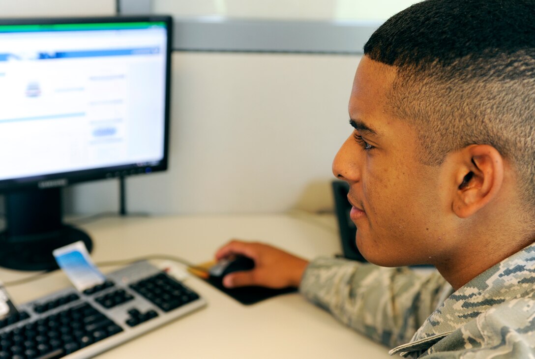 Airman 1st Class Robert Collins, 28th Communications Squadron cyber systems technician, reviews material at his desk in the new 28th CS customer service section located in Bldg. 2010 on Ellsworth Air Force Base, S.D., June 28, 2012. The 28th CS customer service section has moved from its previous location to the former Air Force Financial Services Center administration building across the street from the base dining facility. (U.S. Air Force photo by Airman Ashley J. Cass/Released)