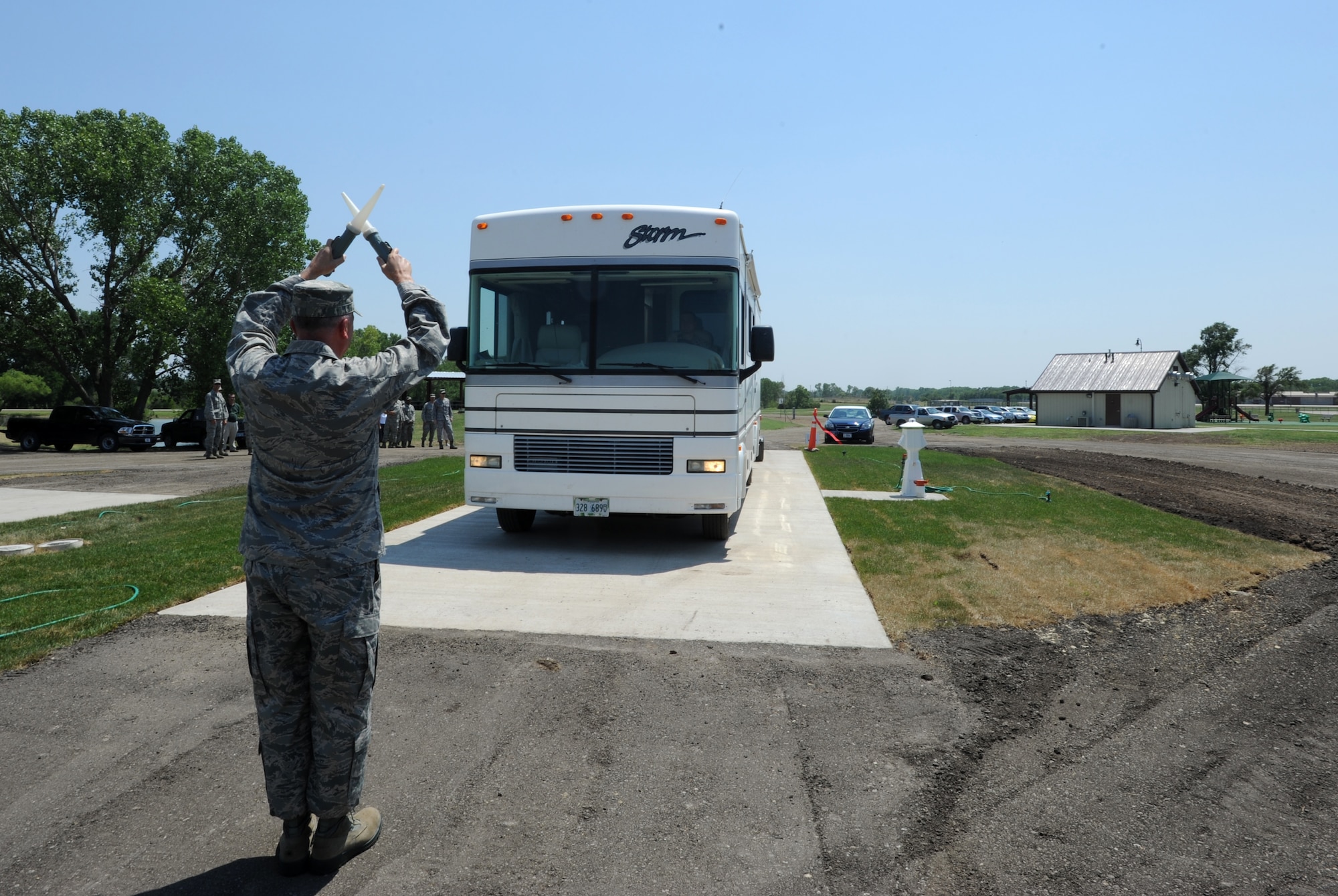 Col. Ricky Rupp, 22nd Air Refueling Wing commander, marshalls the first customer into slot number one at McConnell’s new Family Camp June 28, 2012. The camping area was constructed by the 22nd Civil Engineer Squadron. (U.S. Air Force photo/ Airman 1st Class Laura L. Valentine)