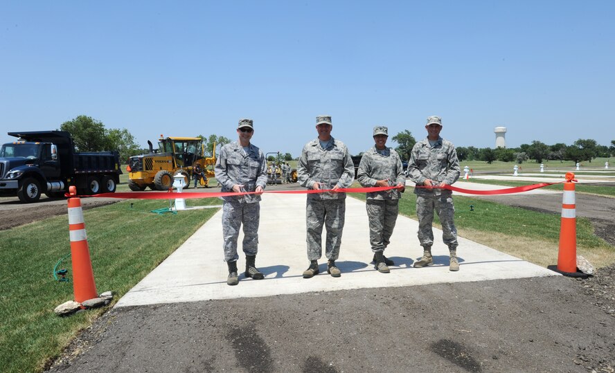 (From left) Col. Mark Evans, 22nd Mission Support Group commander, Col. Ricky Rupp, 22nd Air Refueling Wing commander, Lt. Col. Nicholl Dial, 22nd Force Support Squadron commander, and Airman 1st Class Wesley Grassie, 22nd Civil Engineer pavement and construction equipment apprentice, officially open McConnell's Family Camp June 28, 2012. The family camp was relocated to provide improved amenities for customers.  (U.S. Air Force photo/ Airman 1st Class Laura L. Valentine)