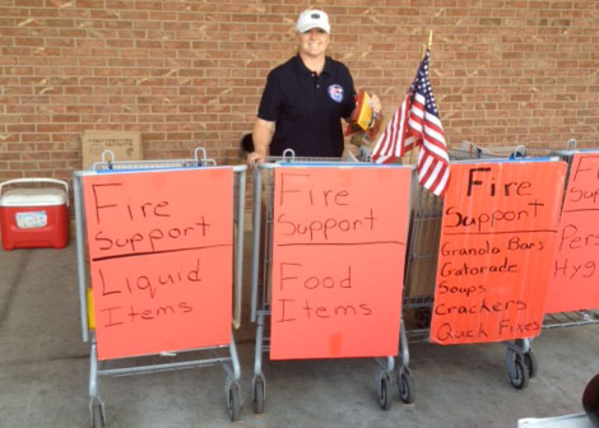 PETERSON AIR FORCE BASE, Colo. - Senior Master Sgt. Lucinda Yslas, Top Three member, collects donations from shoppers at the base Commissary June 28, 2012. The event was sponsored by the Top Three at Peterson AFB, an organization consisting of Airmen from the top three enlisted ranks. Over 2,500 pounds of food were collected by enlisted volunteers for Care and Share to be distributed to firefighters and evacuees of the Waldo Canyon Fire. (Courtesy photo)
