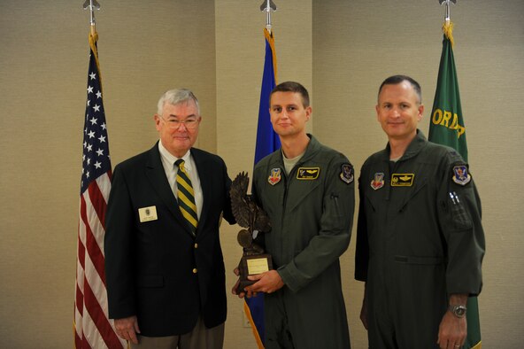Retired U.S. Air Force Lt. Gen. Nicholas Kehoe and Col. Billy Thompson, 23d Wing commander, present the 2011 Daedalian Exceptional Pilot Award to Maj. Pat Dugan, HH-60G Pave Hawk pilot and 23d WG executive officer, at Moody Air Force Base, Ga., June 28, 2012. Selection for this award is based on exceptional deeds performed to assure mission success, acts of valor as an aviator, or an extraordinary display of courage or leadership in the air in support of an air operation. (U.S. Air Force photo by Airman 1st Class Douglas Ellis/Released)
