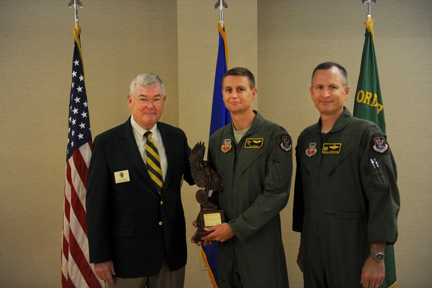 Retired U.S. Air Force Lt. Gen. Nicholas Kehoe and Col. Billy Thompson, 23d Wing commander, present the 2011 Daedalian Exceptional Pilot Award to Maj. Pat Dugan, HH-60G Pave Hawk pilot and 23d WG executive officer, at Moody Air Force Base, Ga., June 28, 2012. Selection for this award is based on exceptional deeds performed to assure mission success, acts of valor as an aviator, or an extraordinary display of courage or leadership in the air in support of an air operation. (U.S. Air Force photo by Airman 1st Class Douglas Ellis/Released)
