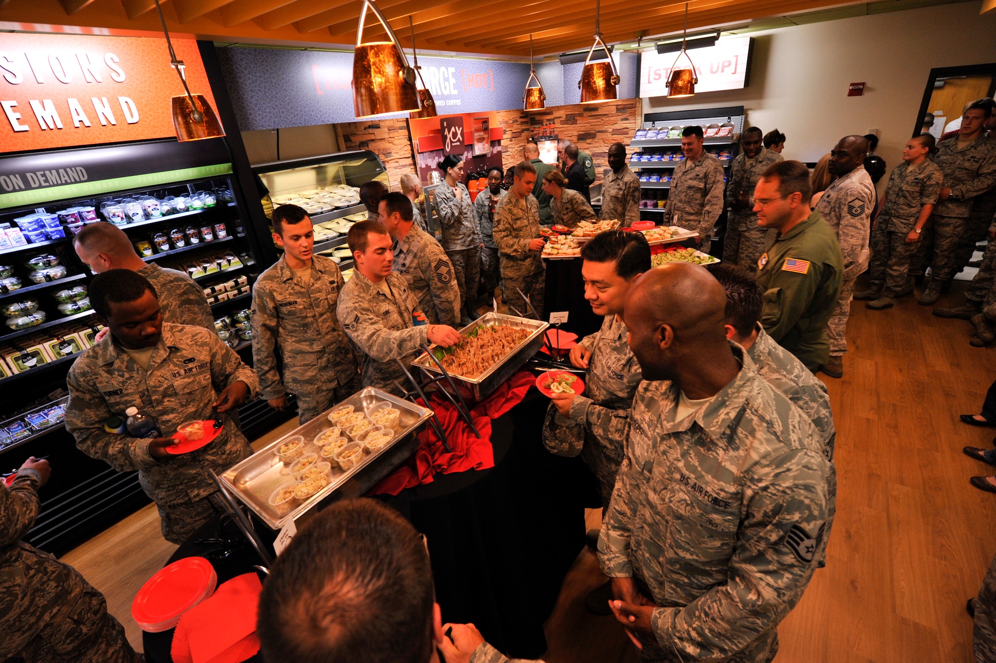 Refreshments are handed out at the provisions on demand facility during the grand opening of the POD June 29, 2012, at Little Rock Air Force Base, Ark. The POD is located in hanger 276 and is opened Monday - Friday 6 a.m. - noon.
(U.S. Air Force photo/A1C Rusty Frank)