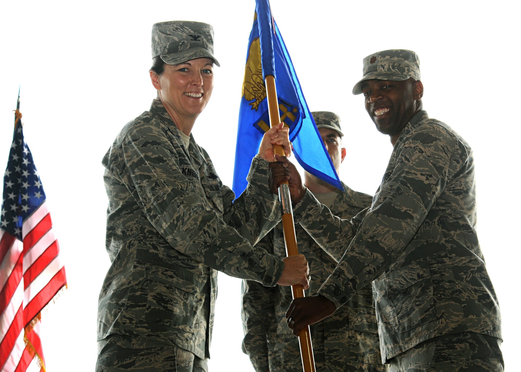Col. Tammmy Knierim, 319th Mission Support Group commander, passes the 319th Logistics Readiness guidon to Maj. Johari Hemphill, during a change of command ceremony, June 27, 2012, on Grand Forks Air Force Base, N.D.  Hemphill assumed command of the 319th LRS from Maj. Reynaldo Gonzalez. (U.S. Air Force photo by Senior Airman Amber Bennett)