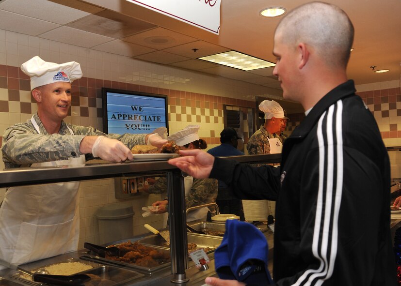 Master Sgt. Patrick Michaels, 319th Security Forces Squadron first sergeant, serves food to Airman 1st Class Jon Stansbury, 319th Civil Engineer Squadron, during an Airmen Appreciation Dinner on June 27, 2012, on Grand Forks Air Force Base, N.D. The dinner was held at the Airey Dining Facility by 319th Air Base Wing leadership to thank Airmen for all they do. (U.S. Air Force photo by Airman 1st Class Xavier Navarro)
