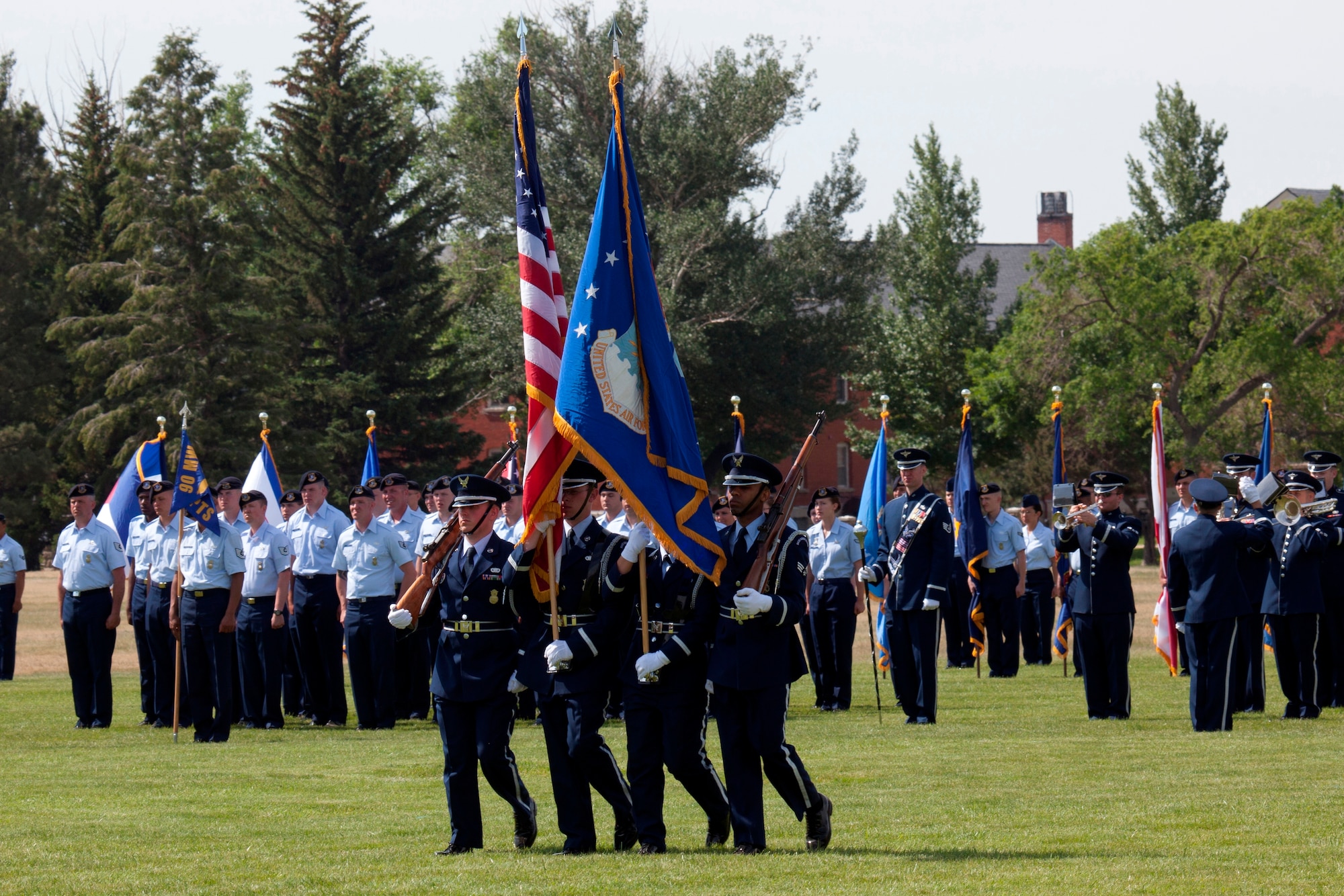 Members of the 90th Missile Wing Honor Guard participate in the pass and review portion of the 20th Air Force and Task Force 214 change-of-command ceremony June 22. Maj. Gen. Michael J. Carey assumed command of 20th AF and Task Force 214 on the Historic Argonne Parade Field at F.E. Warren Air Force Base, Wyo. (U.S. Air Force photo/Matt Bilden)