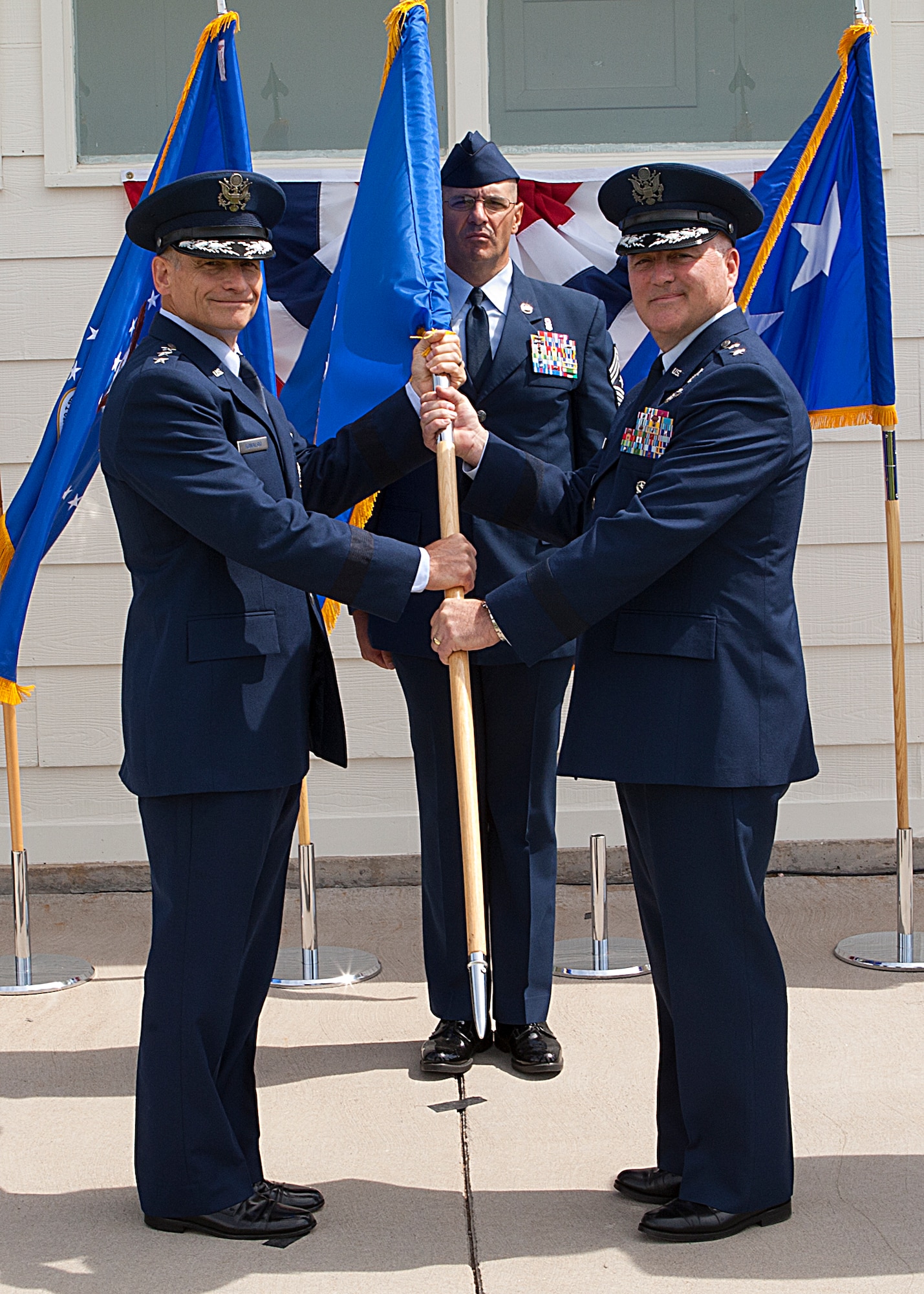 Lt. Gen. Jim M. Kowalski, commander of Air Force Global Strike Command, passes the 20th Air Force Flag to Maj. Gen. Michael J. Carey during a change-of-command ceremony June 22 on the Historic Argonne Parade Field at F.E. Warren Air Force Base, Wyo. (U.S. Air Force photo/Matt Bilden)