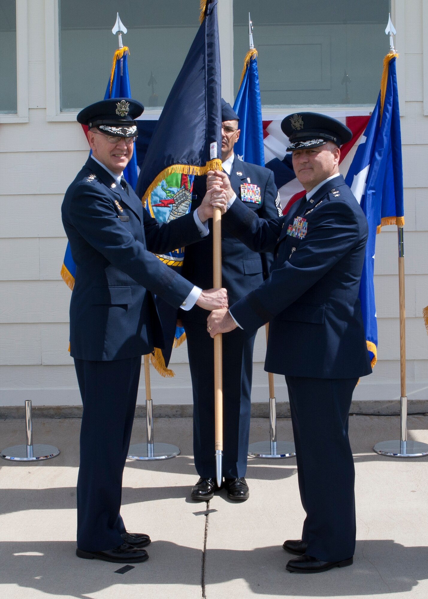 Gen. C. Robert Kehler, commander of U.S. Strategic Command, passes command of Task Force 214 to Maj. Gen. Michael J. Carey. Carey assumed command of 20th AF and Task Force 214 during a change-of-command ceremony June 22 on the Historic Argonne Parade Field at F.E. Warren Air Force Base, Wyo. (U.S. Air Force photo/Matt Bilden)